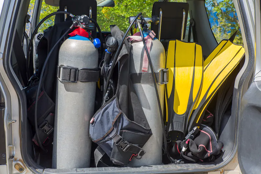 scuba gear in the back of an SUV with the trunk open