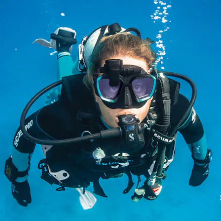 scuba diver underwater facing camera