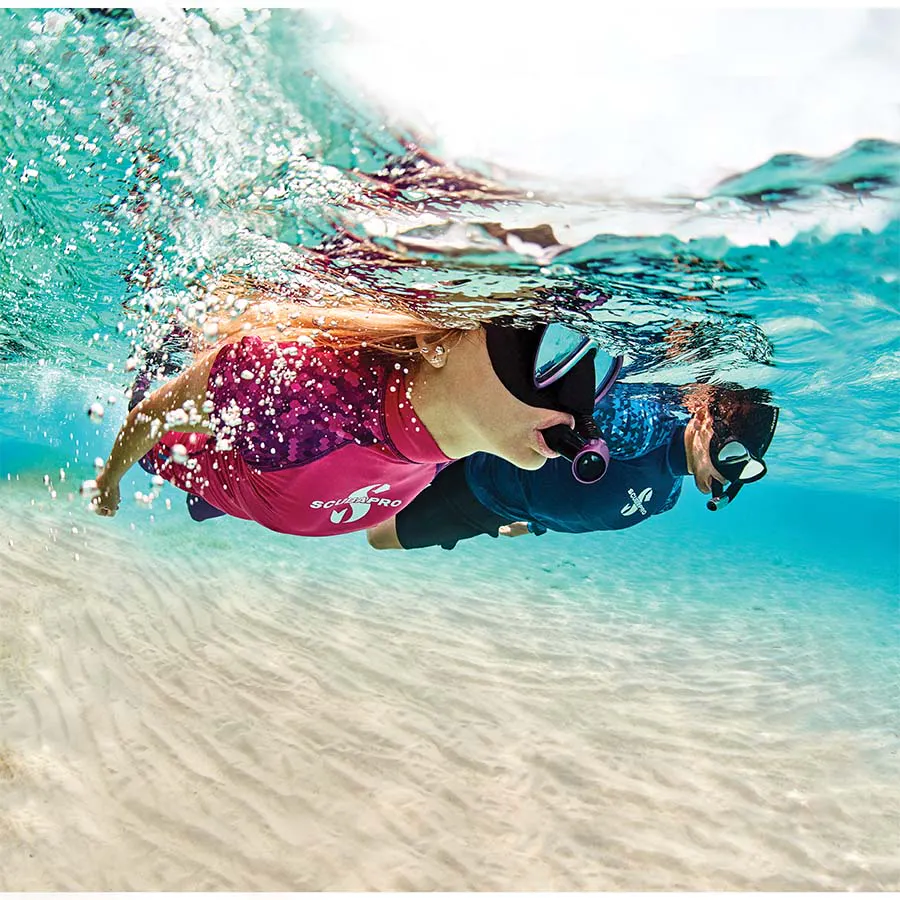 couple snorkeling in clear, shallow waters
