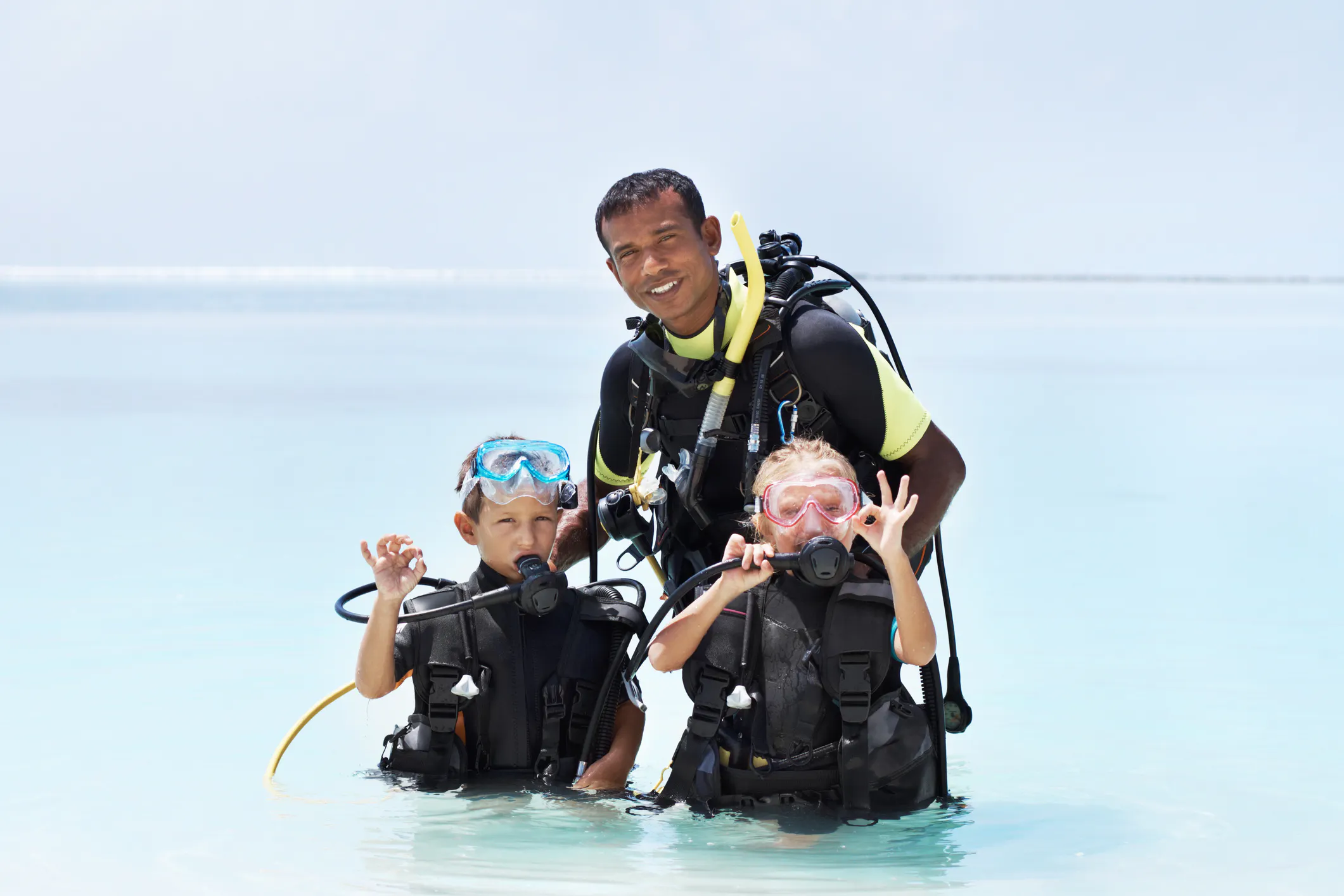 Scuba diving instructor with two children student