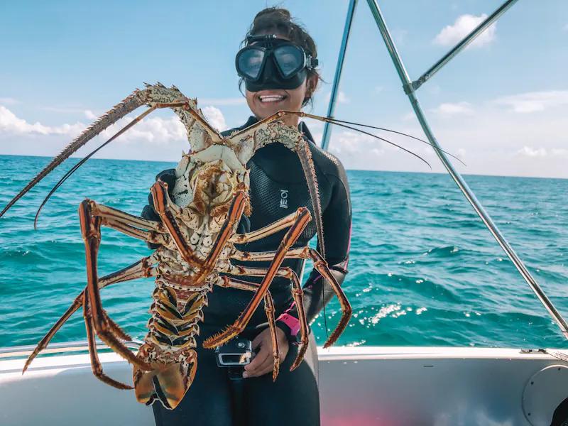 female diver with lobster