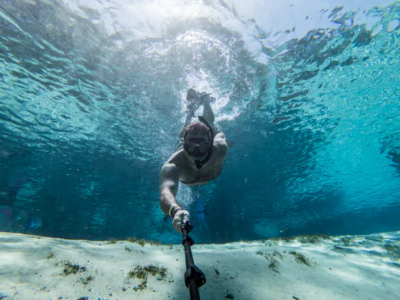freediver with camera underwater