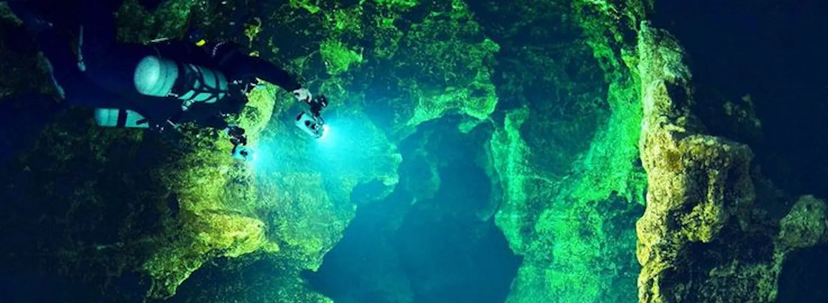 diver exploring cave