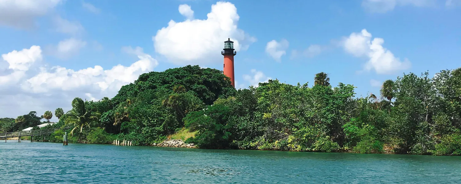 water and land. a lighthouse on land