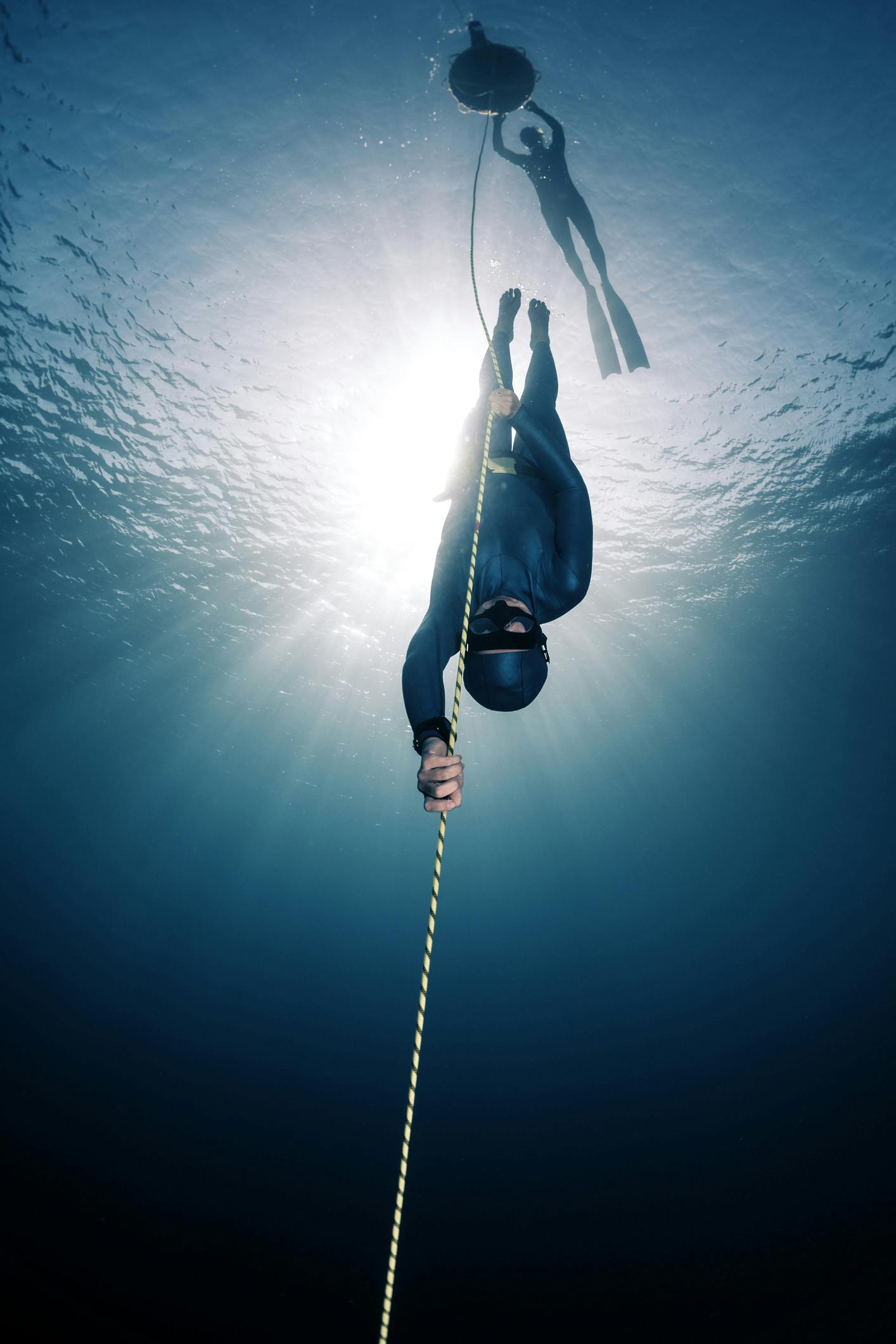 freediver in the water doing free immersion down the line