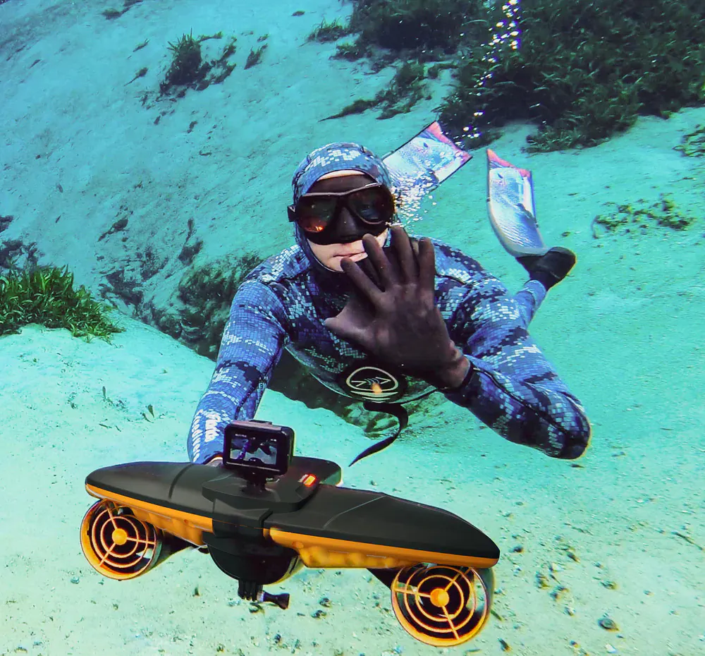 freediver using underwater scooter in a spring
