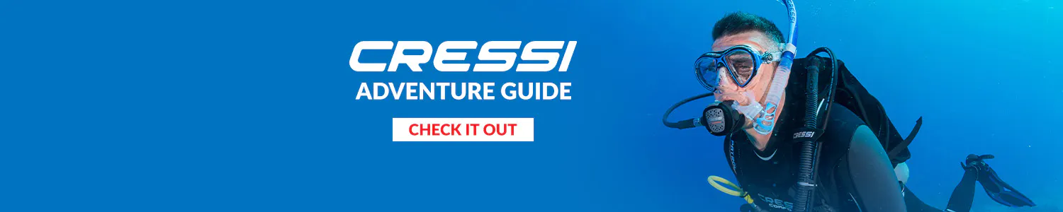 Cressi Adventure Guide banner. Male scuba diver with a blue background 