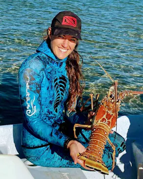 girl holding big lobster out of water