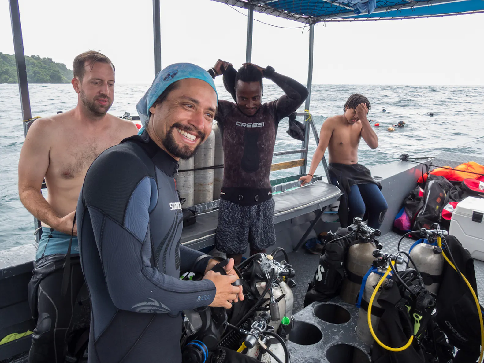 Scuba divers on a charter with scuba gear.