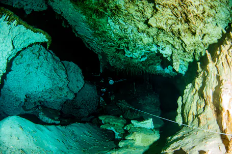 scuba diver in cavern with line deployed