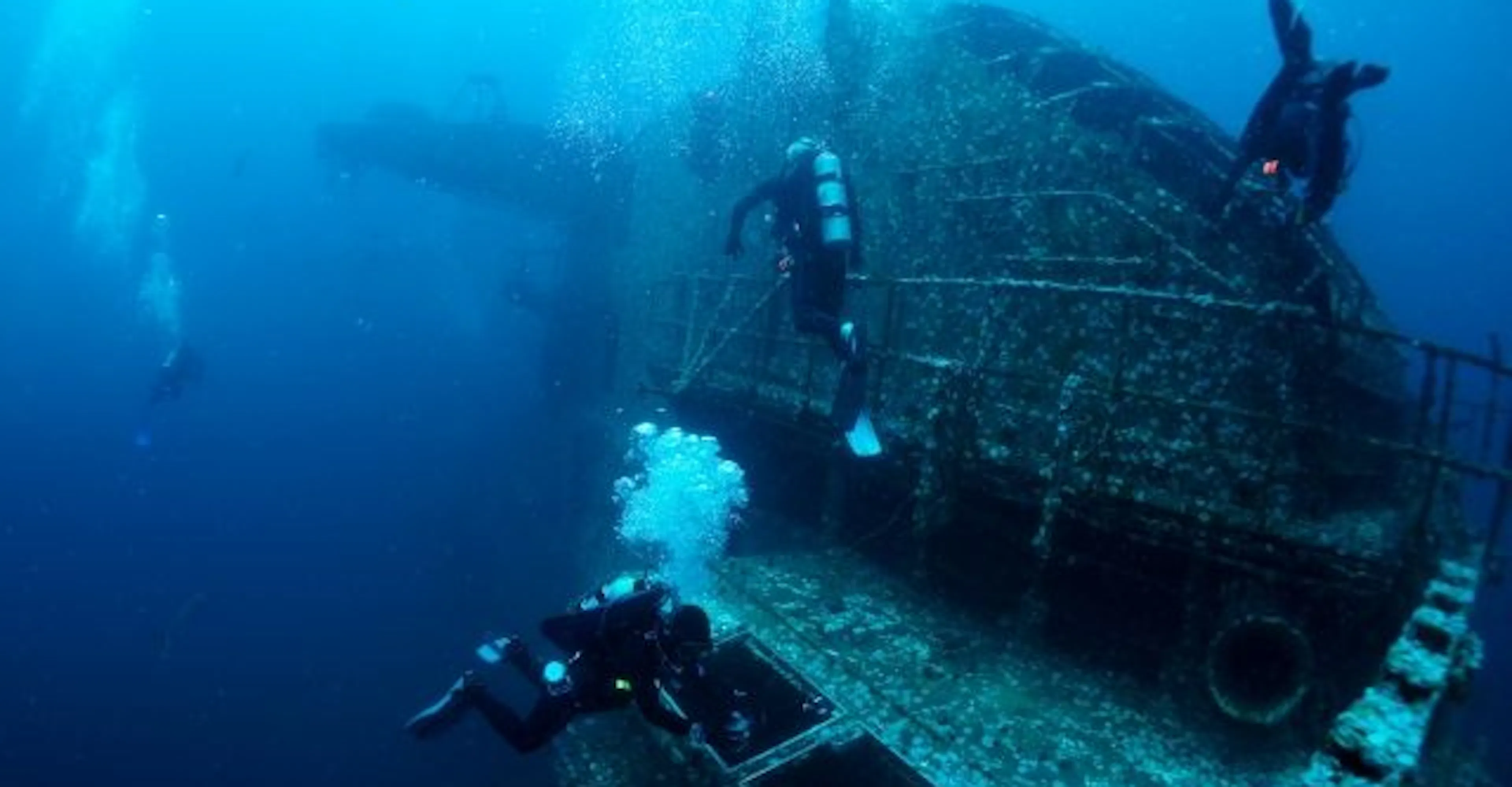 sunken wreck being explored by divers