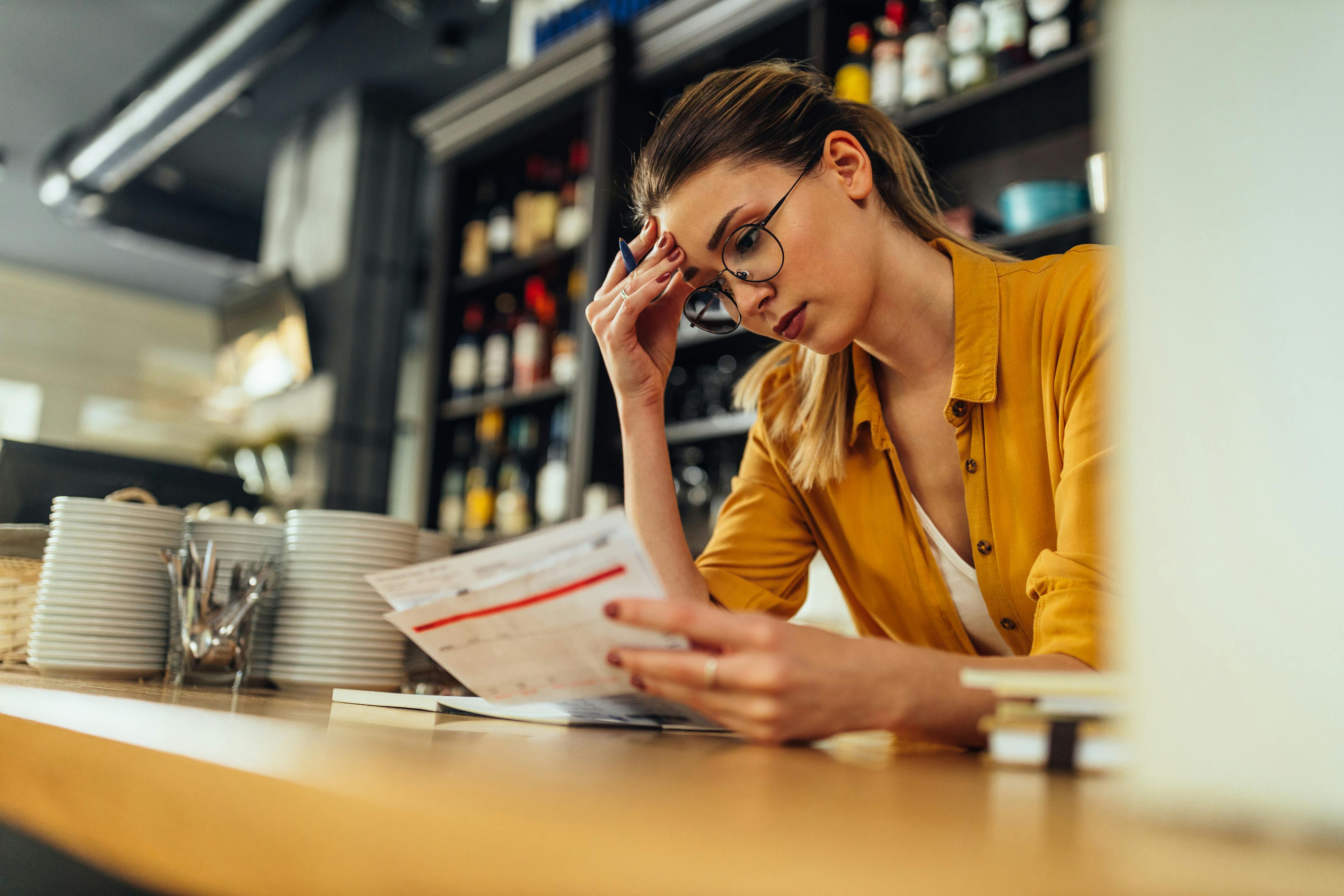 Business owner checking bills.