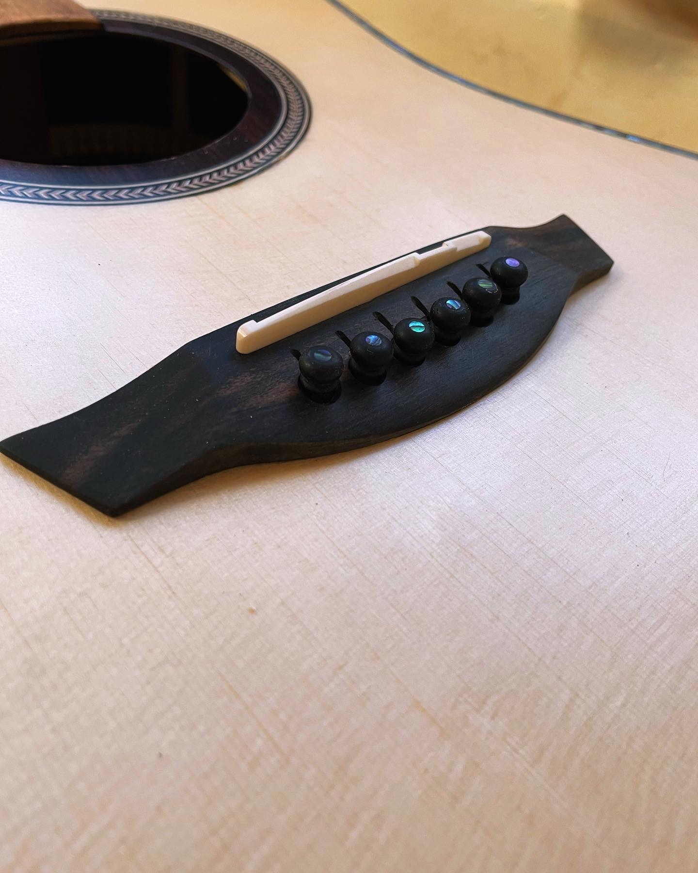 j-45 guitar bridge close up image