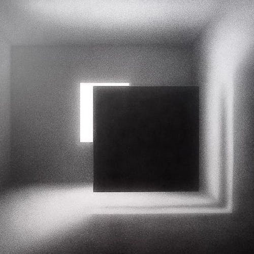 empty room with a source of light and a dark floating square