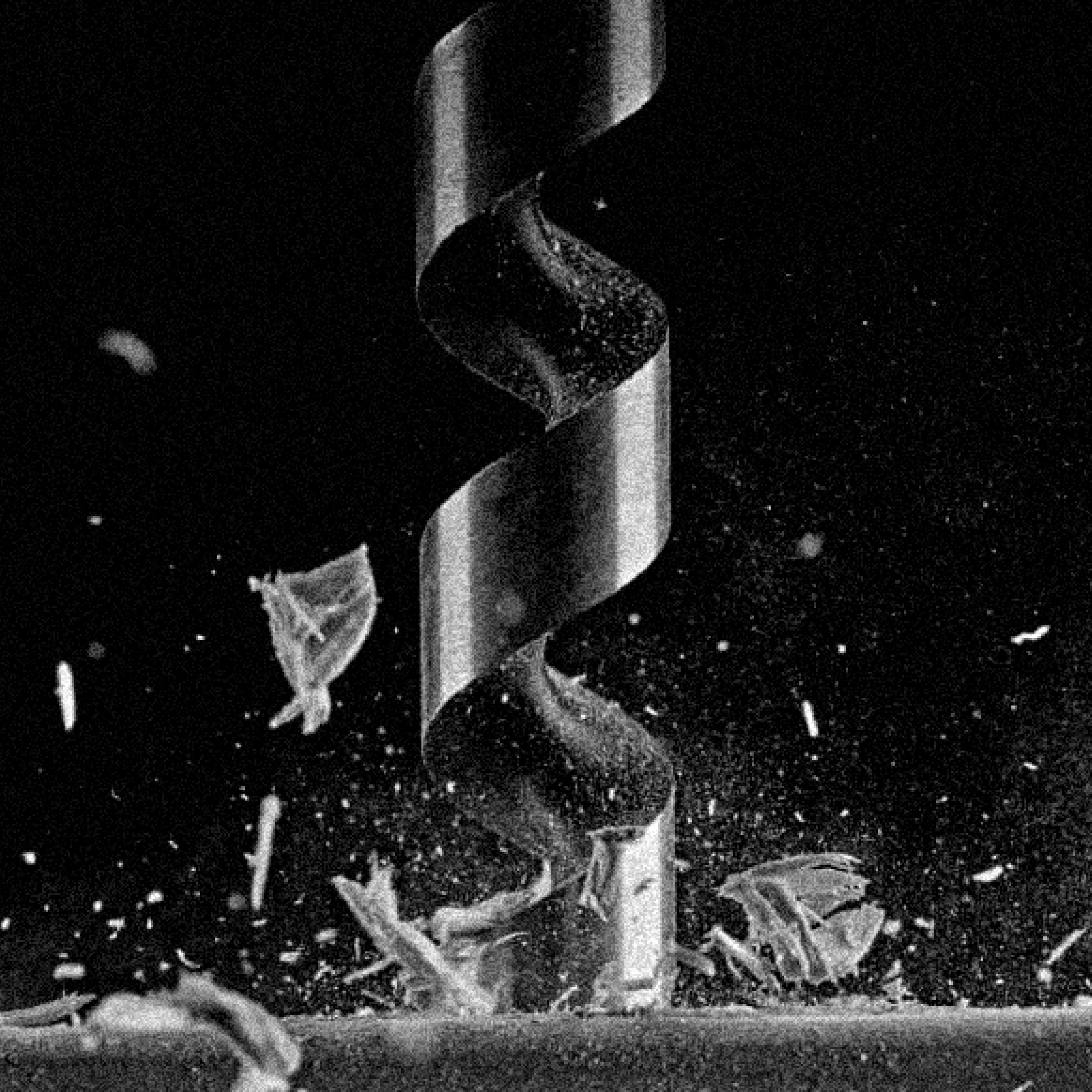 closed-in photo of a drill making a hole