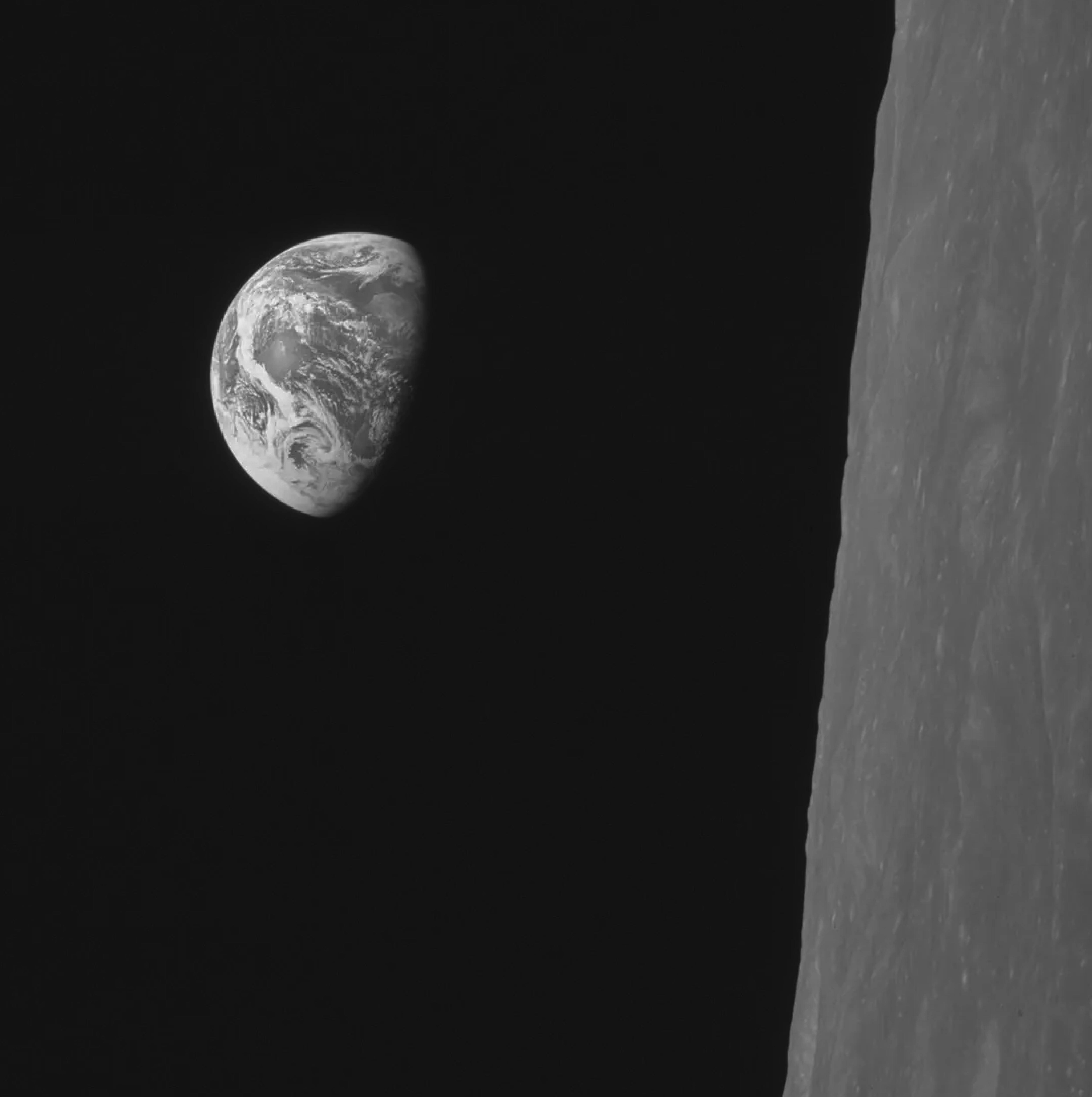 photo of Earth from the distance showing part of the moon closer