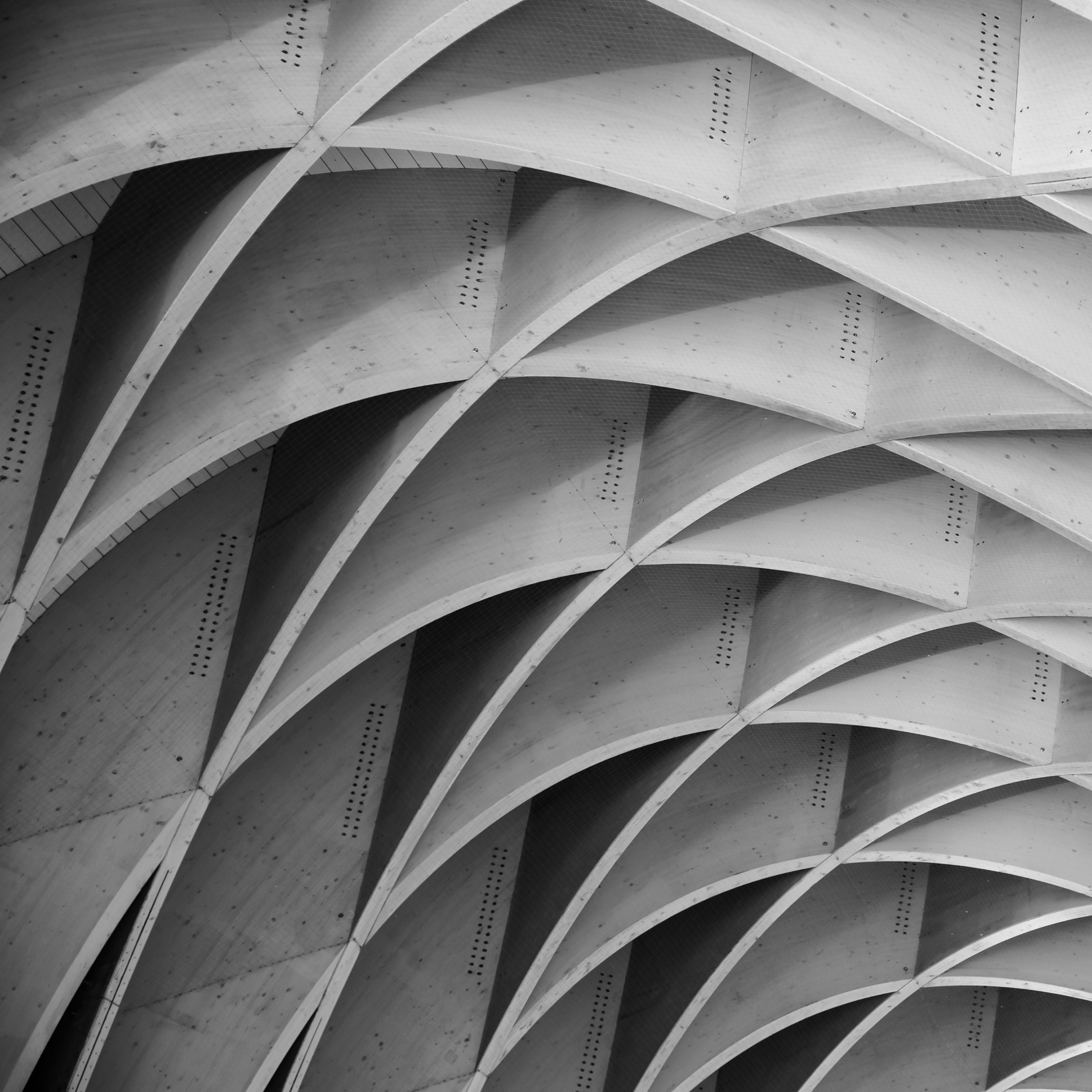 photo of geometric arches in a building forming a pattern