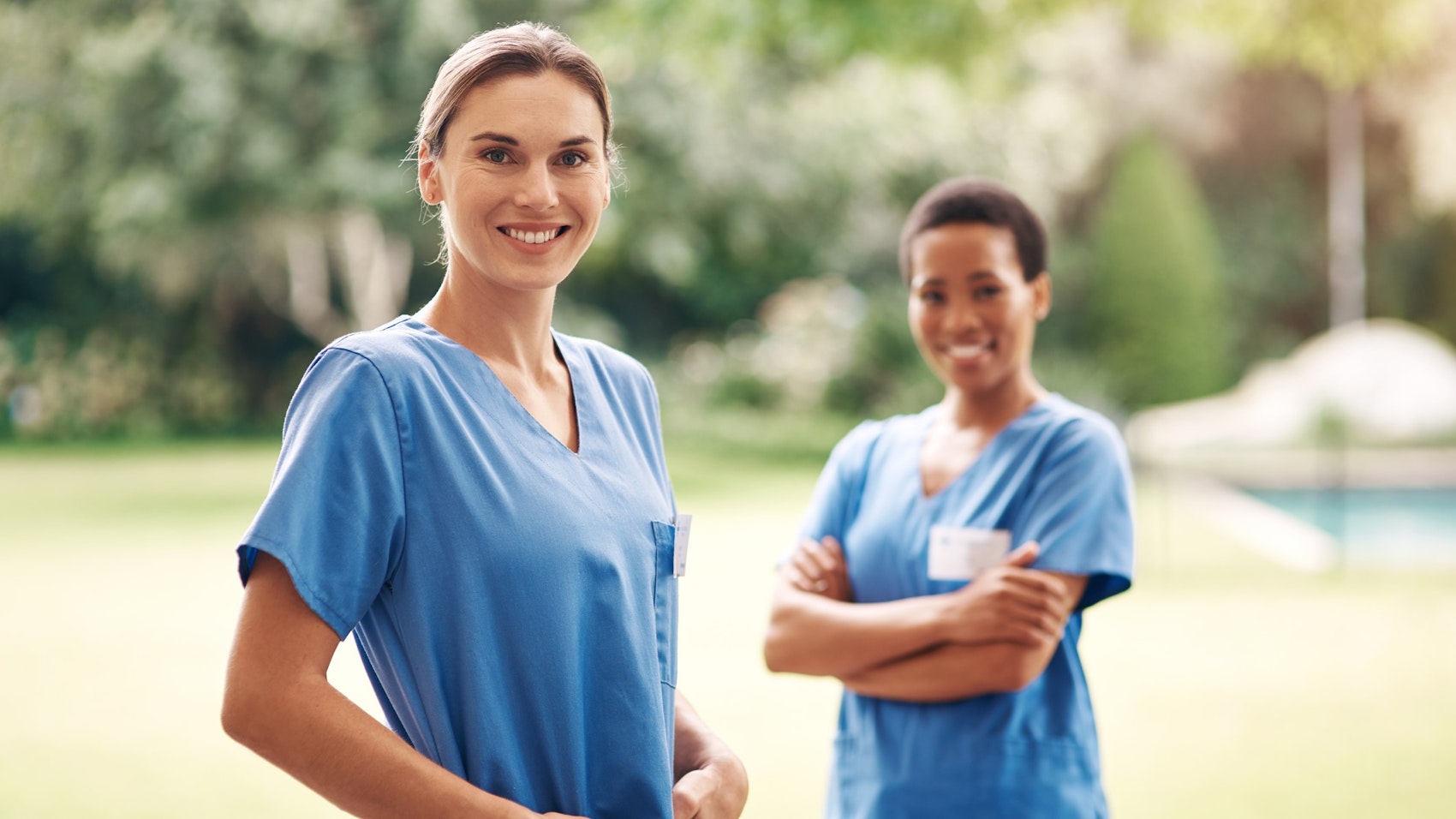 Zwei Krankenschwestern lächeln in die Kamera