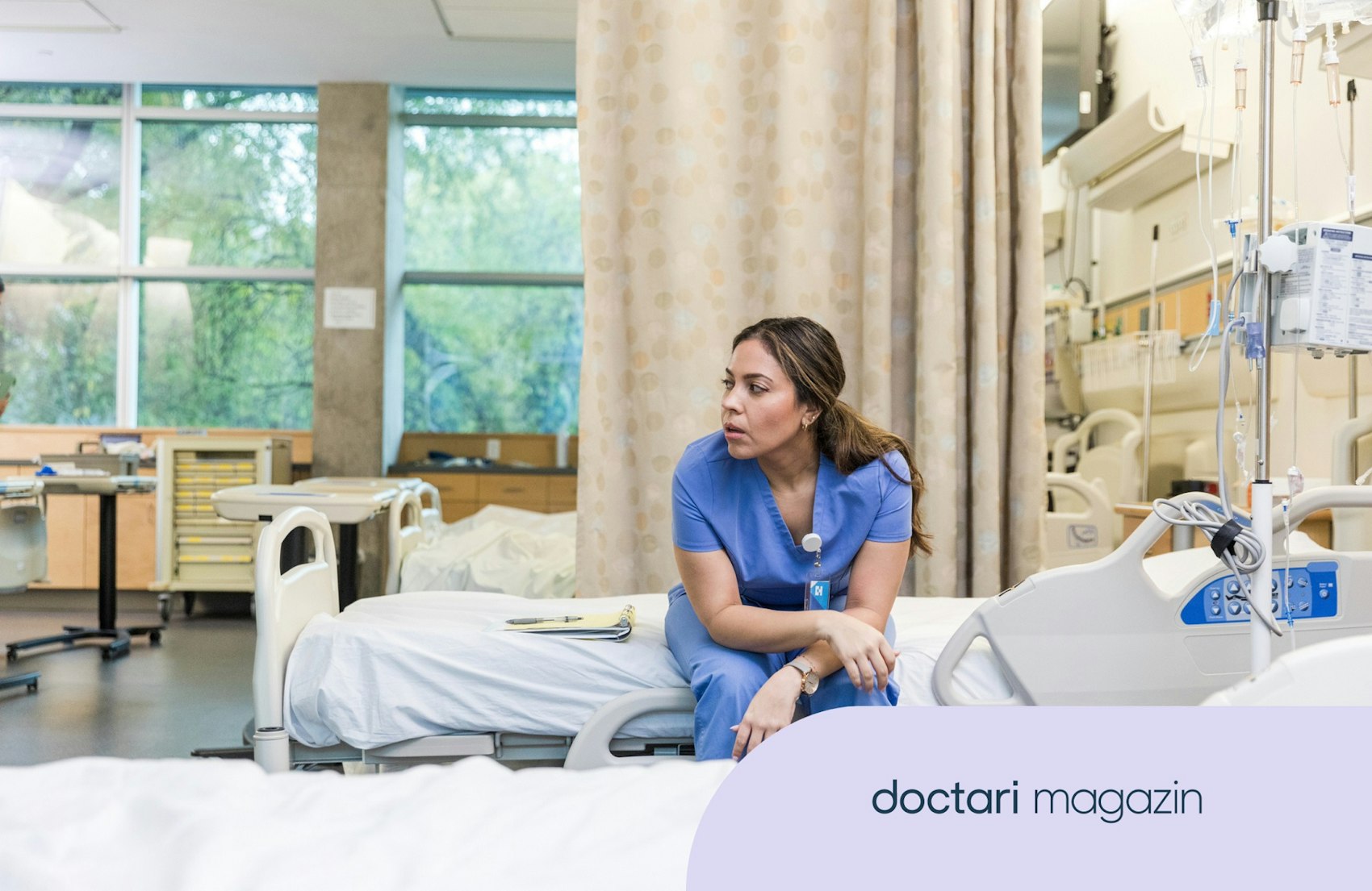 Erschöpft aussehende Krankenschwester sitzt alleine auf einem leeren Krankenhausbett.