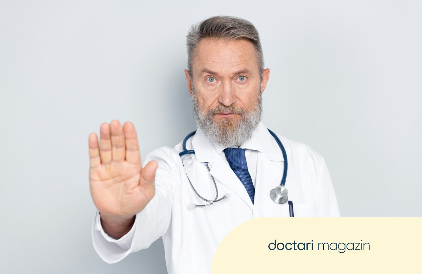 Ein Arzt hält abwehrend eine Hand vor seinen Körper