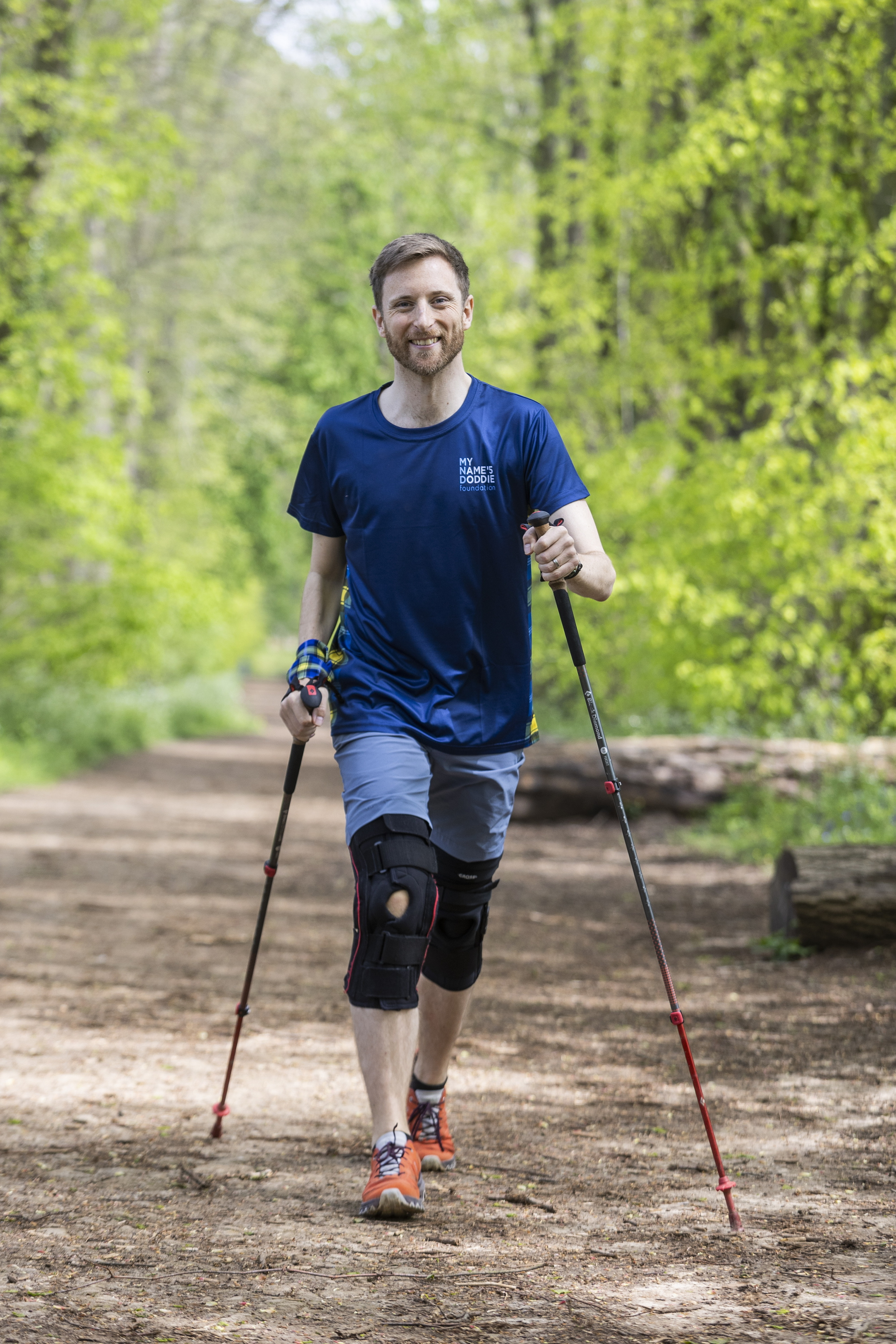 Smiling hiker in a Doddie Aid t-shirt.