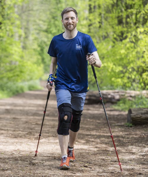 Smiling hiker in a Doddie Aid t-shirt.