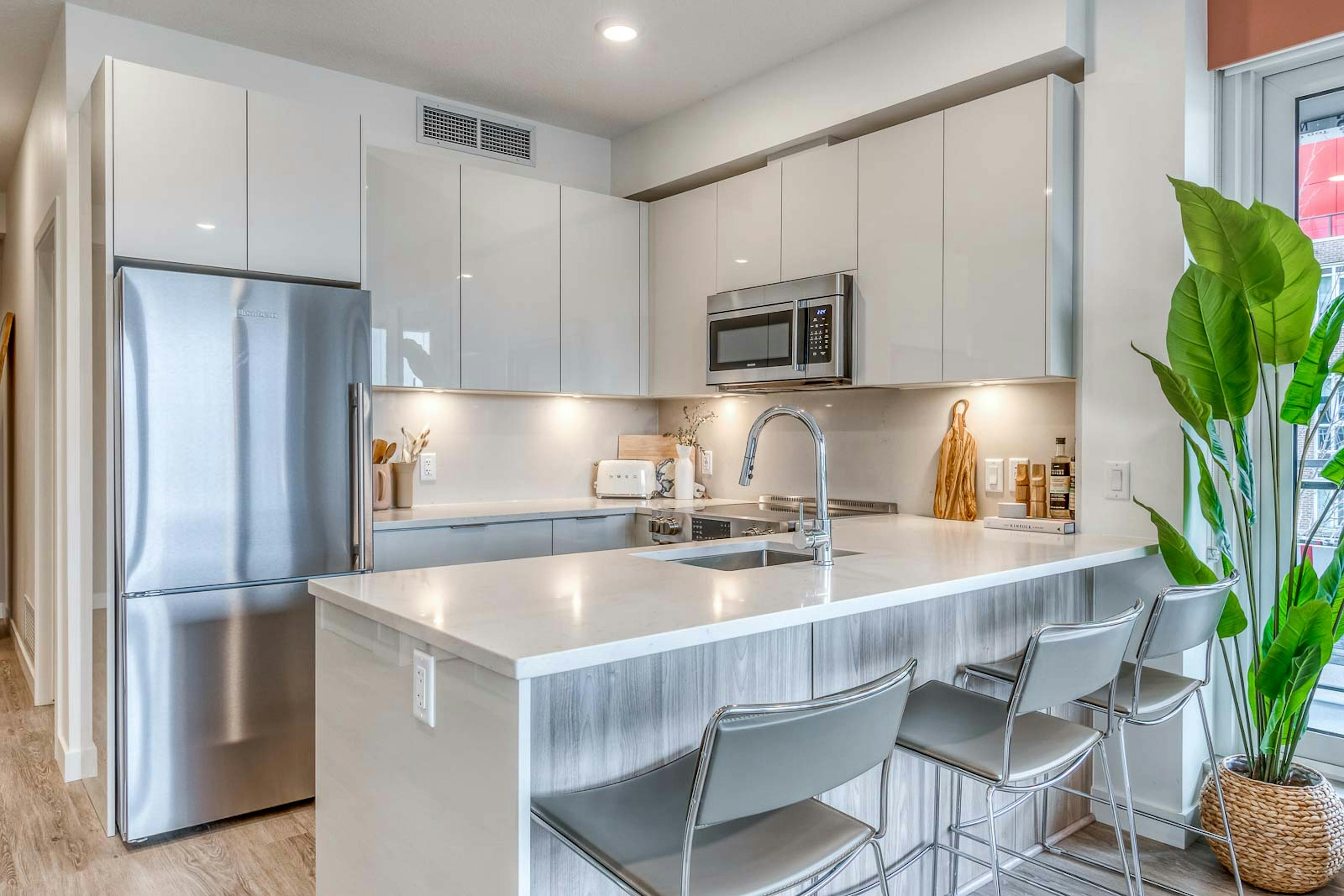 Dominion large 2 bedroom kitchen with modern cabinets, stainless steel appliances, quartz backsplash and counter tops. 