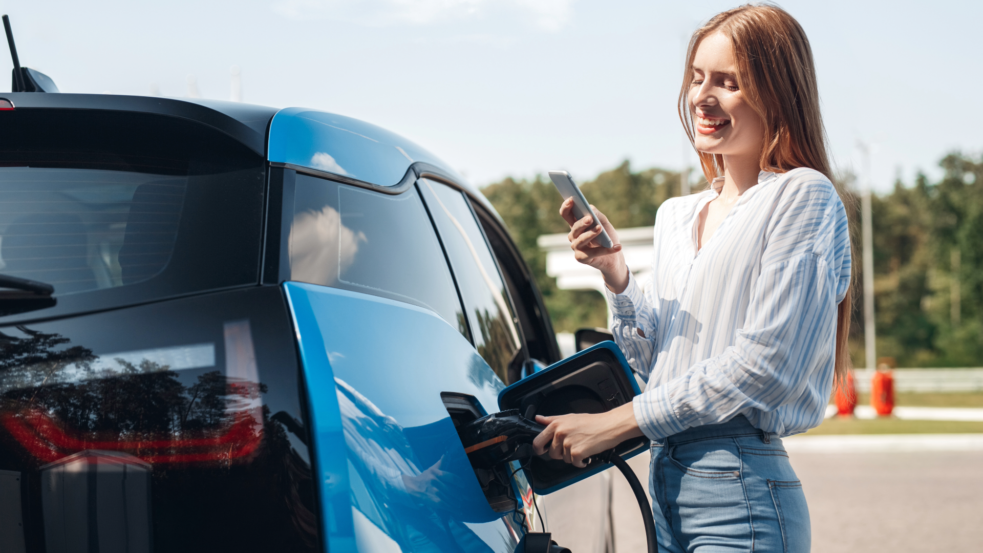A woman charging an EV