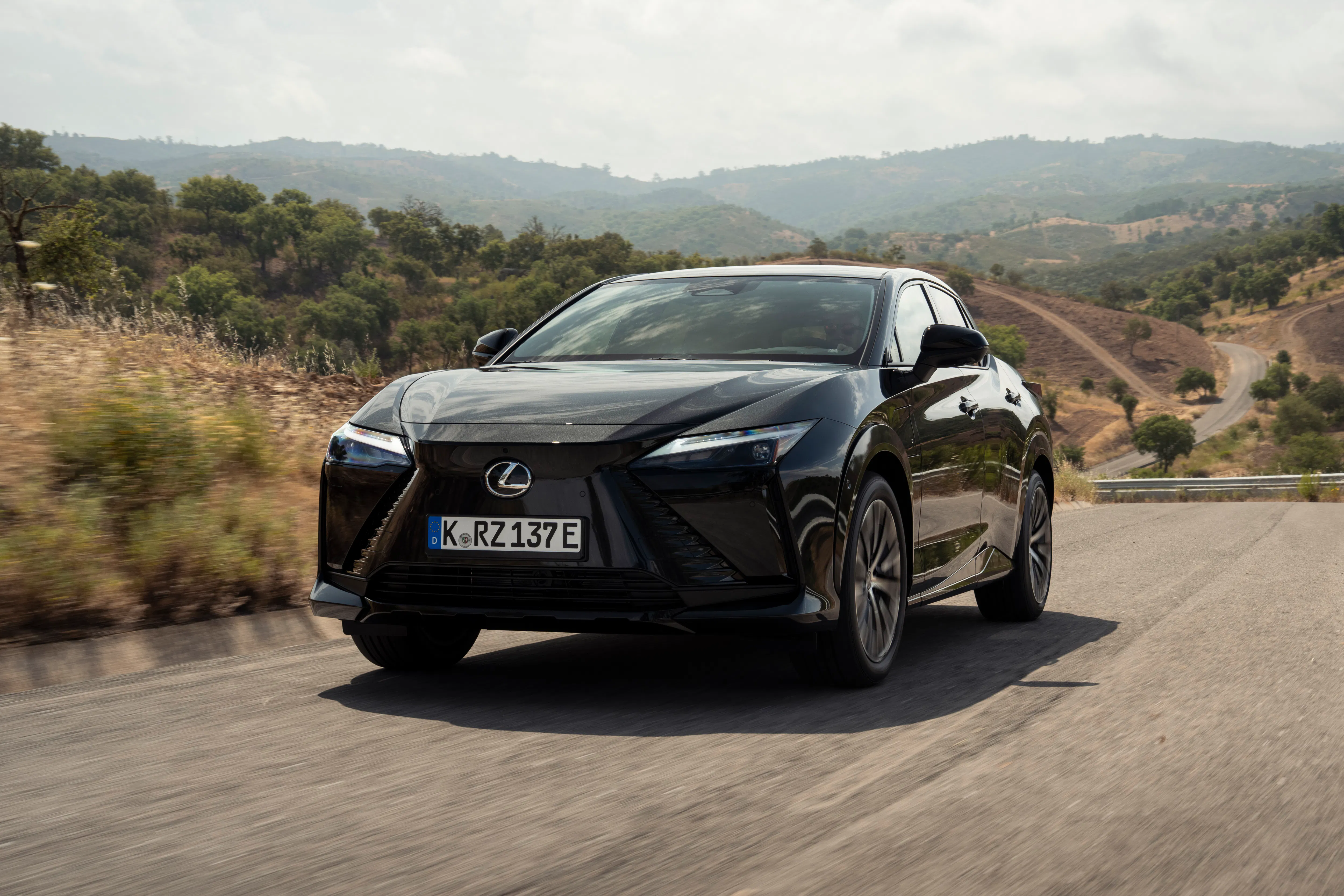 A Lexus RZ500e driving on a motorway - Image 1