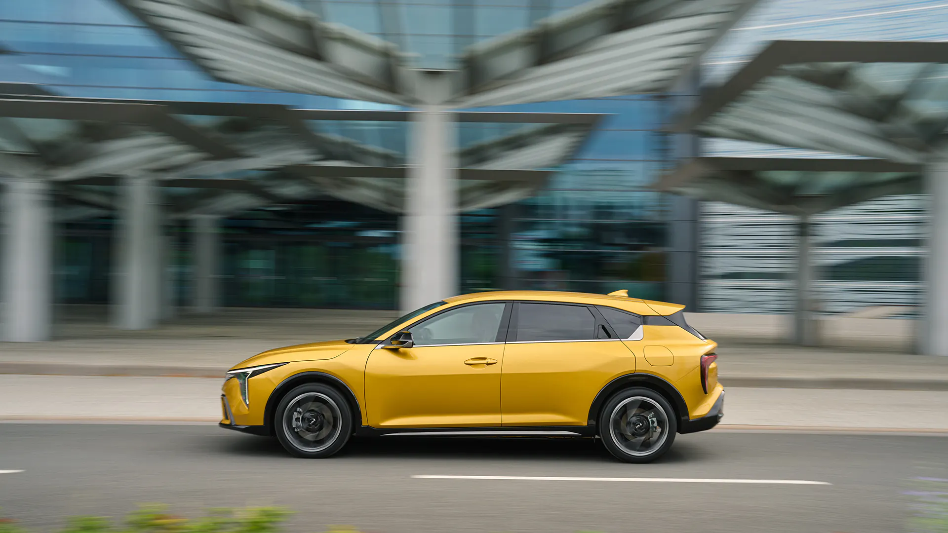 A Kia K4 driving on a road - Image 3