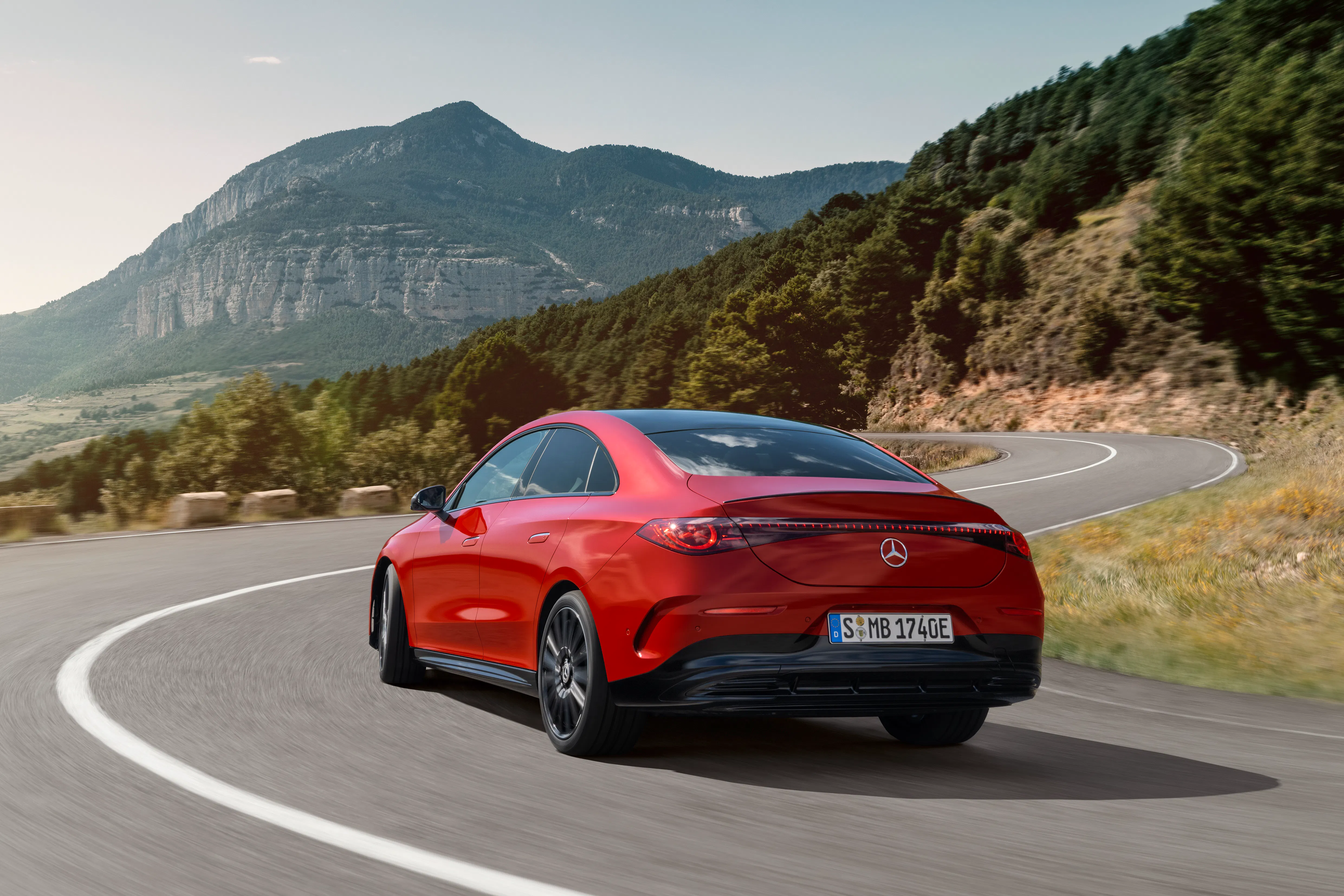 A red Mercedes CLA driving on a country road - Image 2