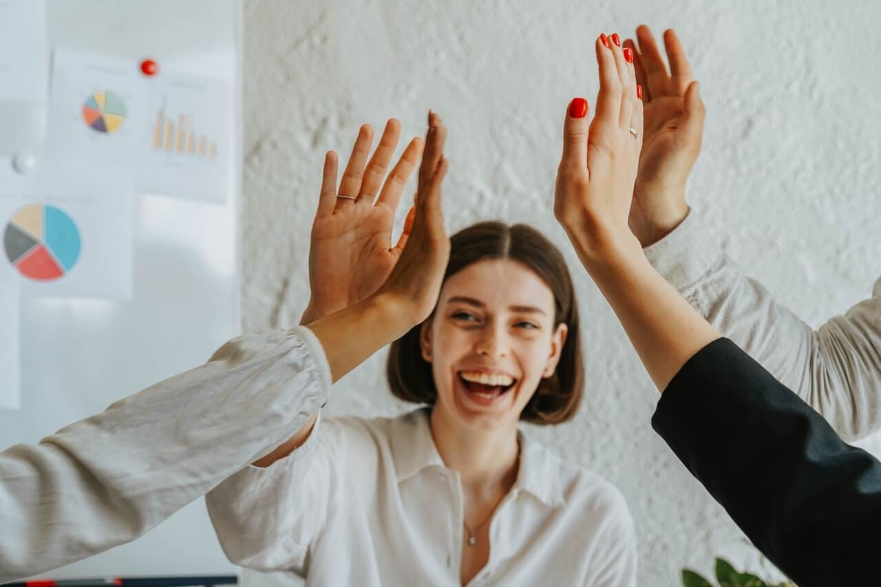 Team high fiving and bonding in an activity