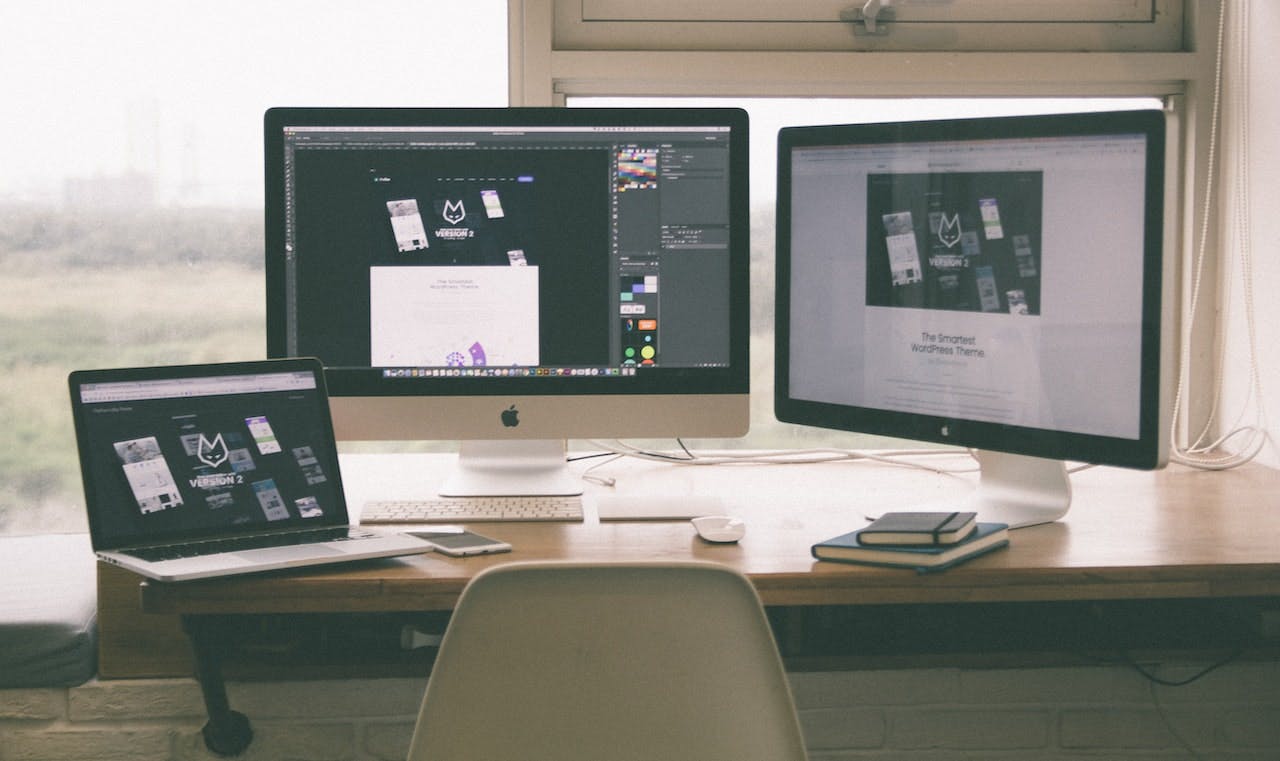 Modern workplace with laptop and 2 screens