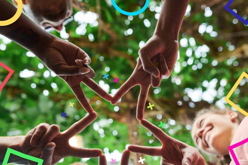 Team pointing fingers together