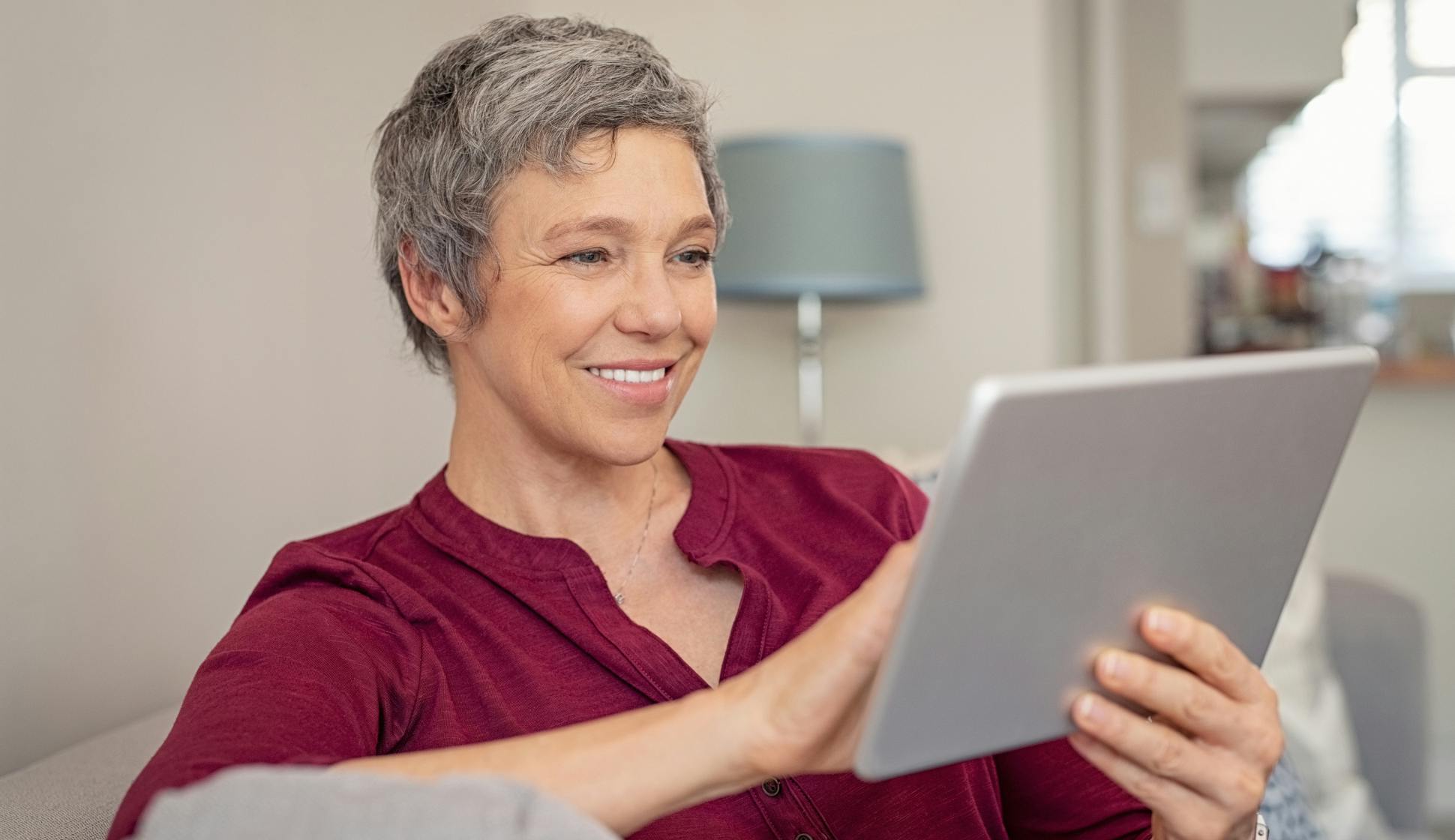Mid age woman during a online counseling session on her tablet device.