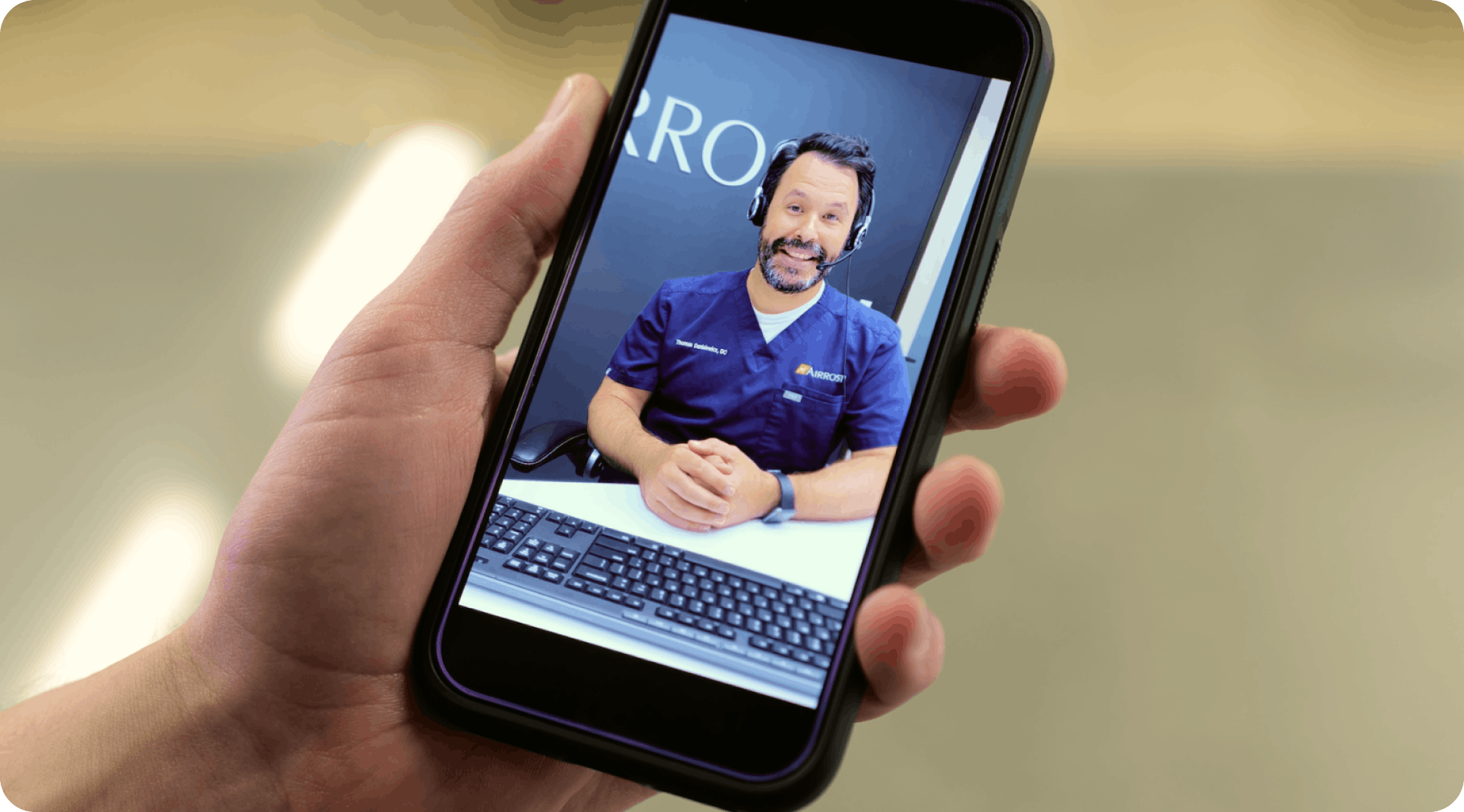 A mobile phone screen showing a telehealth MSK appointment with an Airrosti specialist