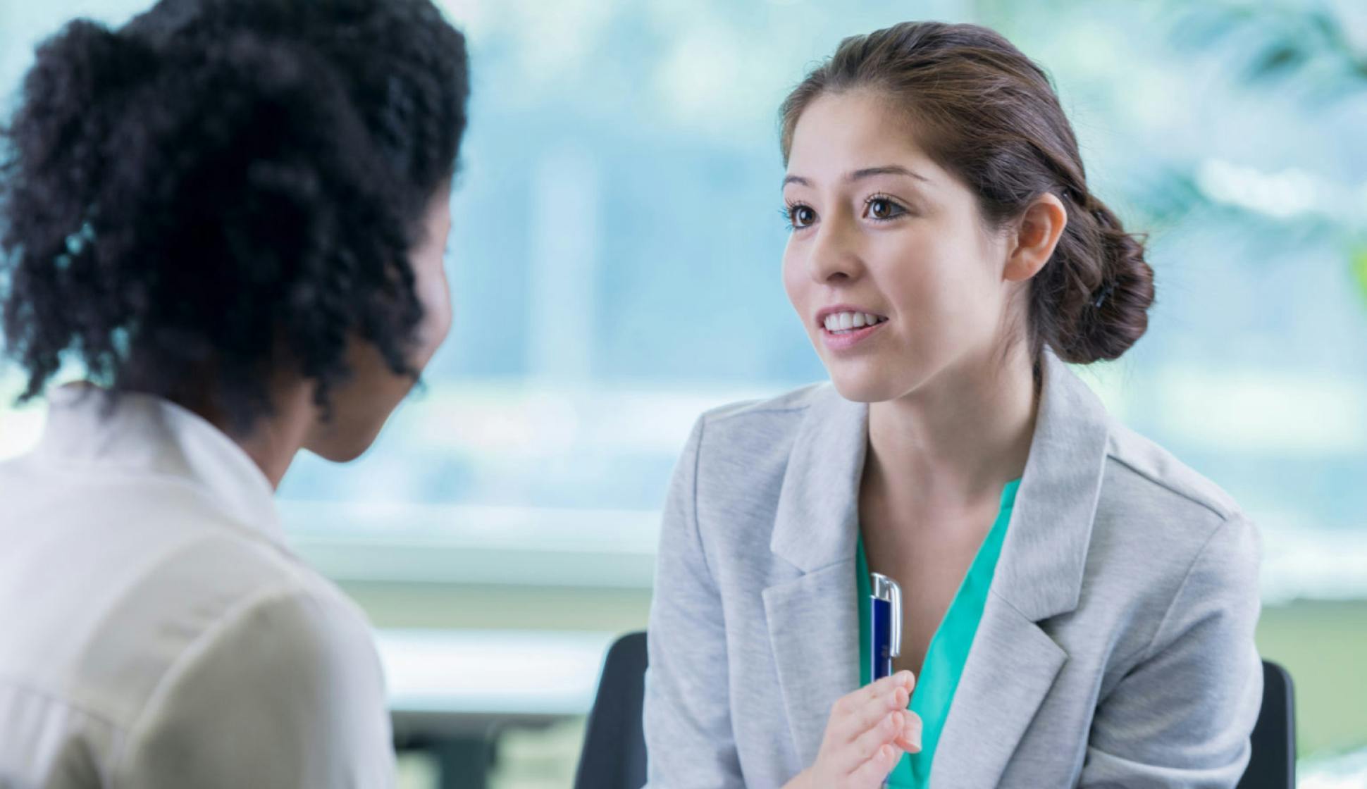 Young female patient answering questions asked by provider