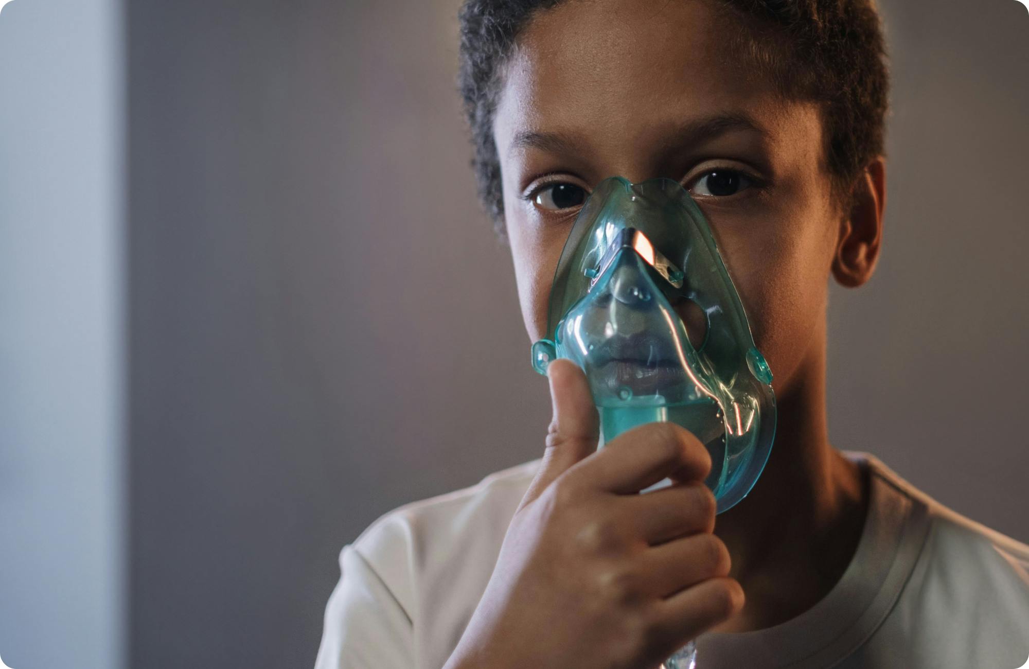 Child with asthma using an inhaler