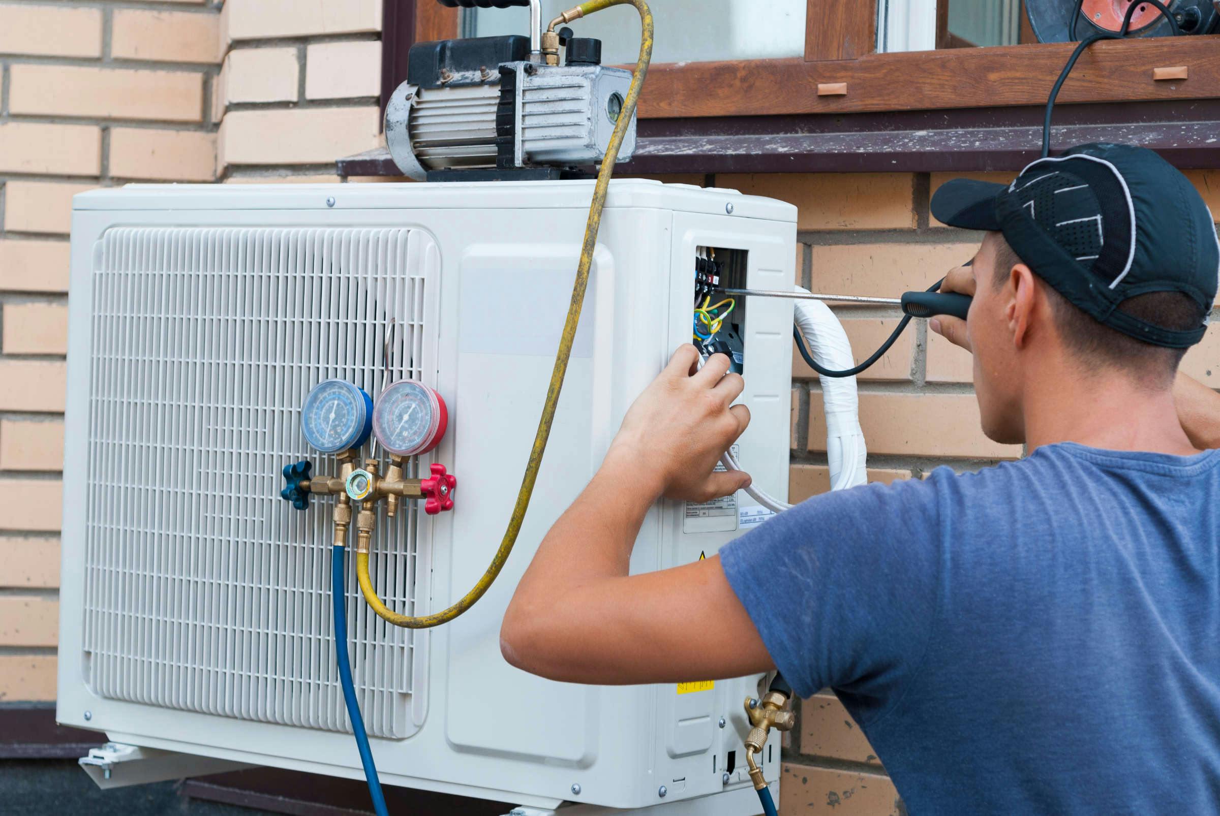 Close-up of technician install air conditioner