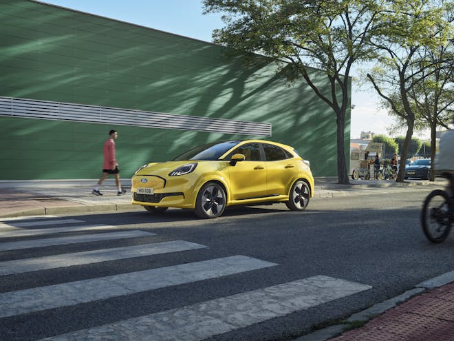 Ford Puma Gen e yellow electric car side profile at zebra crossing 