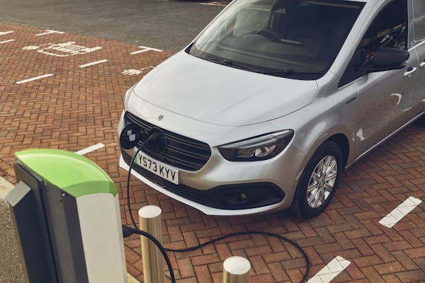 Silver mercedes electric van using public charger