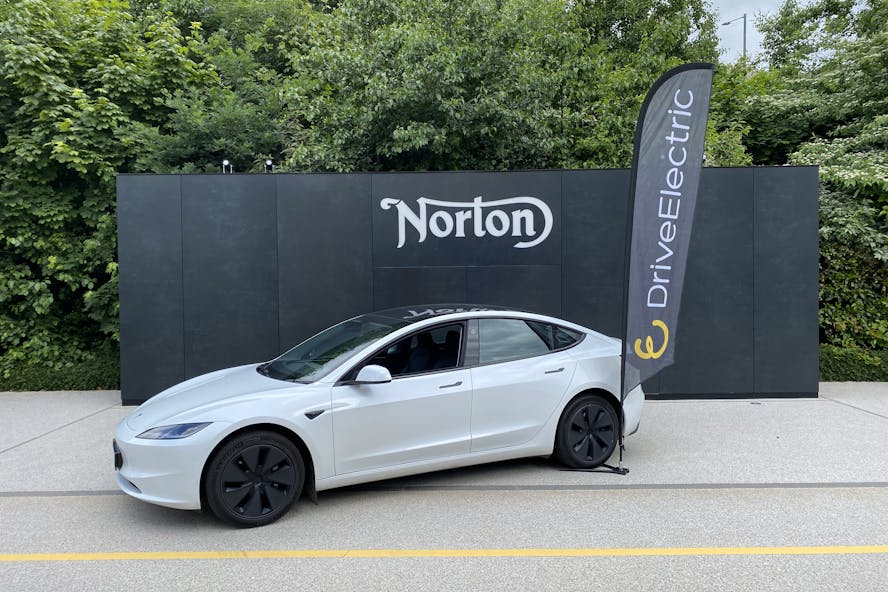 A white Tesla Model 3 parked outside Norton Motorcycles HQ in Solihull, UK