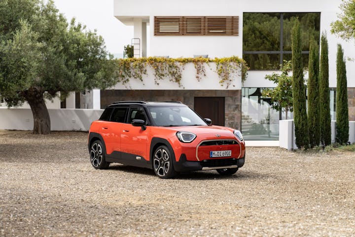 mini aceman electric car in orange parked on driveway