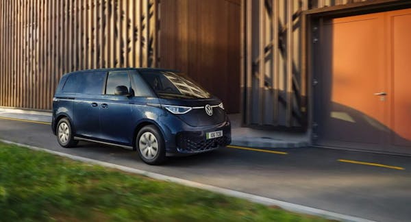 volkswagen id buzz cargo electric van in navy, parked at warehouse 