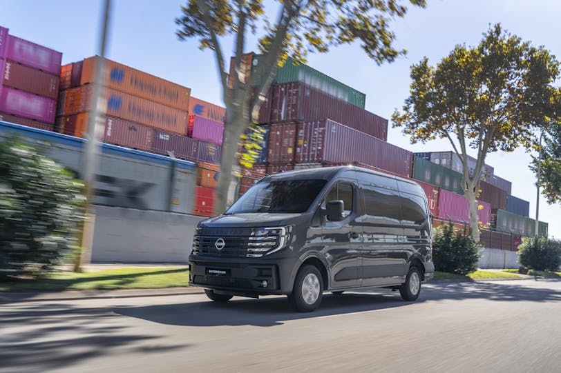 Nissan Interstar electric van with shipping containers in background 