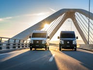 2 nissan interstar electric vans driving on bridge