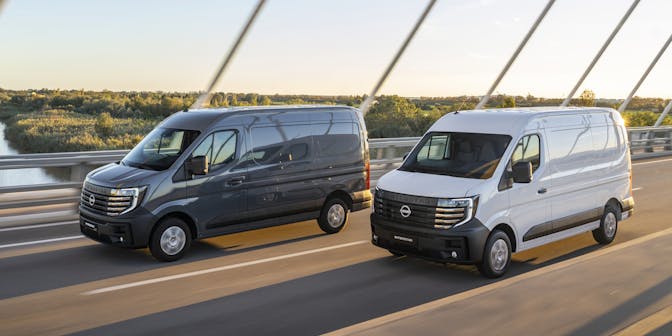 2 nissan interstar electric vans driving on bridge  side view