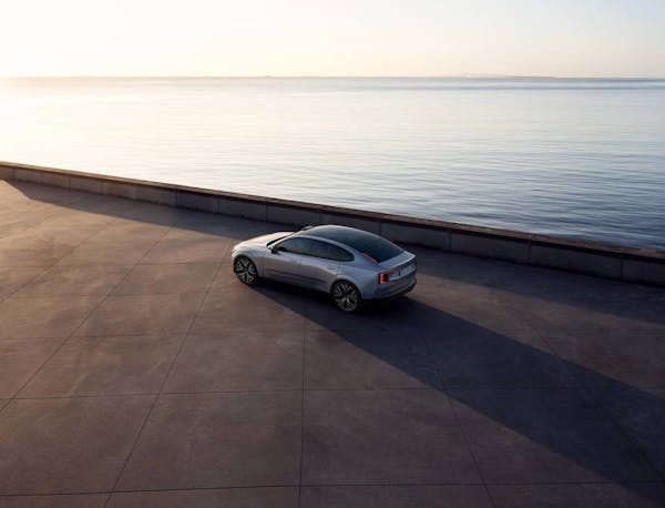 Volvo ES90 ariel shot of electric car next to body of water