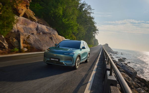 Geely ex5 electric car driving on coastal road