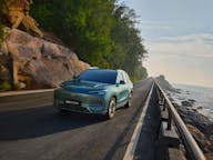 Geely ex5 electric car driving on coastal road